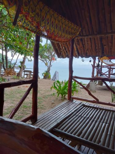 a porch of a hut with a view of the beach at Breizh Cape Beach Bungalows in Ko Lanta