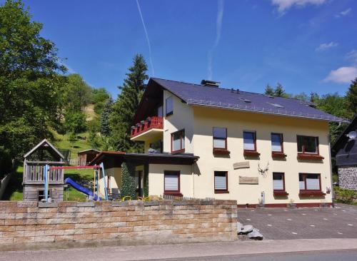 a house with a playground in front of it at Upland Apartments - Fewo Zeitgeist (inkl. MeineCardPlus) in Willingen