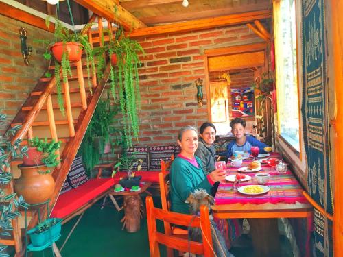 a group of people sitting at a table at Hospedaje Vertientes del Imbabura in Otavalo