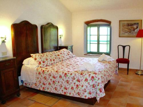 a bedroom with a large bed and a red chair at Apartment in Collesalvetti near Pisa in Guasticce