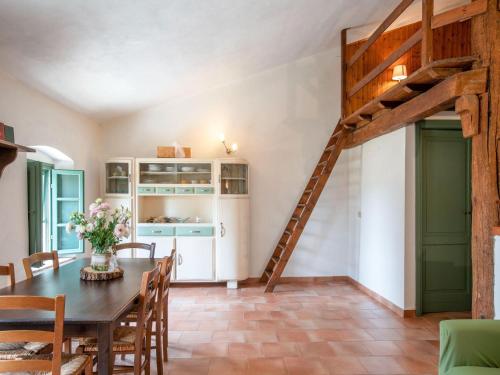 a dining room with a wooden table and a ladder at Apartment near Pisa, Beaches in Guasticce