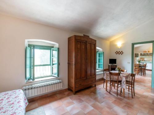a room with a table and a cabinet and a dining room at Apartment near Pisa, Beaches in Guasticce