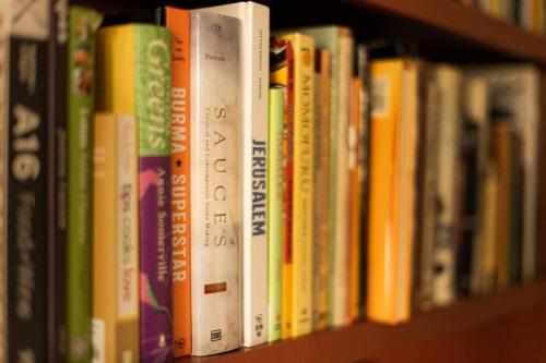 a row of books on a book shelf at Luxury Living in Historic Bank Haven of Art&Music in Tomales