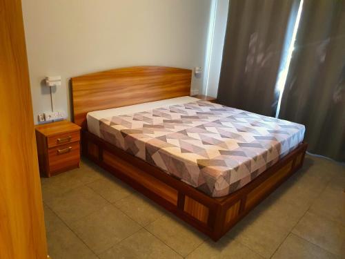 a bedroom with a bed and a night stand at Malvilla in Pereybere