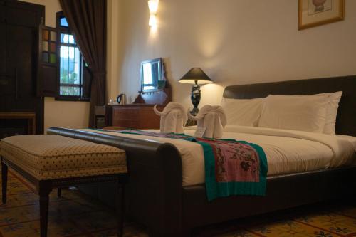a hotel room with a bed with towels on it at Areca Hotel Penang in George Town