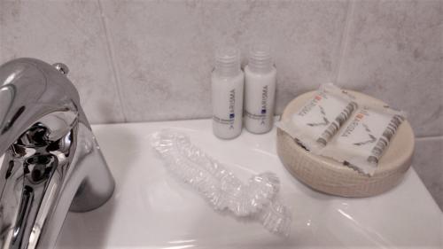 a bathroom sink with two bottles of toothbrushes on it at Venice Suites in Mestre