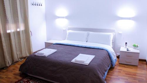 a bedroom with a large bed with two towels on it at Venice Suites in Mestre