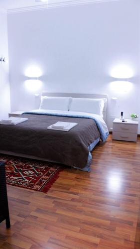 a bedroom with a bed and a wooden floor at Venice Suites in Mestre