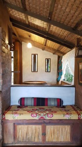 a bedroom with a bed in a room at Greenleas, Cottage, Swimming Pool and Log Fire in Mae Chan