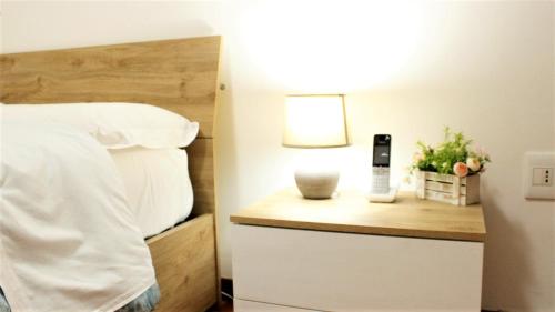 a bedroom with a bed and a phone on a night stand at Venice Suites in Mestre