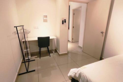 a bedroom with a desk and a chair in a room at Kulai d putra suites beside ioiMall near JPO and Airport in Kulai