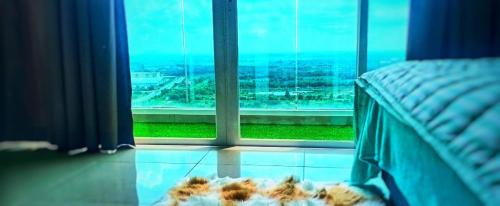 a bedroom with a bed and a large window at My Dallyne's Homestay at Mutiara Ville Cyberjaya in Cyberjaya