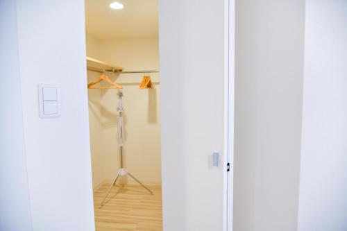 two views of a closet with a glass door at GLASS Yamahana EAST in Minami-jūichijō