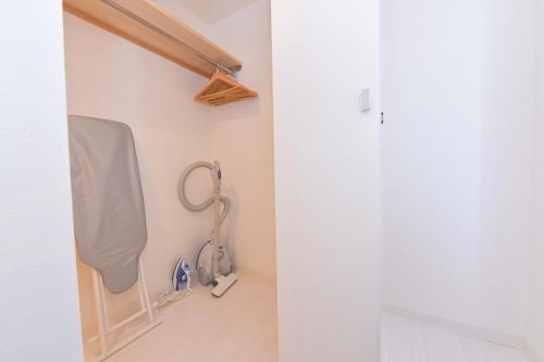 a bathroom with a sink and a shower curtain at GLASS Yamahana EAST in Minami-jūichijō