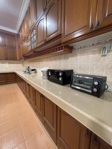 a kitchen with a counter with a toaster oven on it at Villa Ruby - with private swimming pool in Kota Bharu