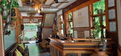 a lobby of a restaurant with a counter and a room at Maladiwa Beach & Spa in Maafushi