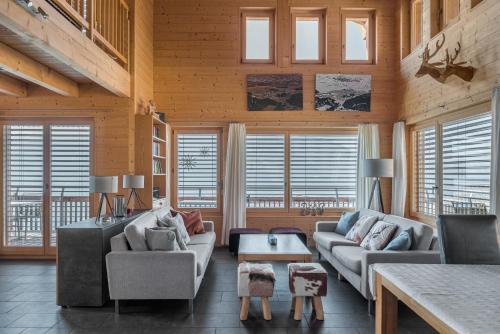 a living room with two couches and a table at Aarninkhof in Bettmeralp