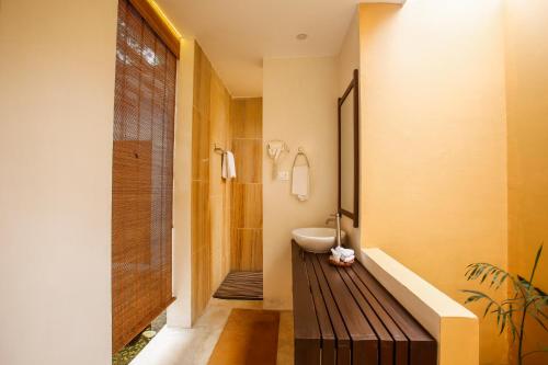 a bathroom with a sink and a toilet and a tub at Kasara Chitwan in Chitwan