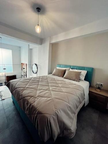 a bedroom with a large bed in a room at Escala Luxury Loft 2 in the center &Free Parking in Volos