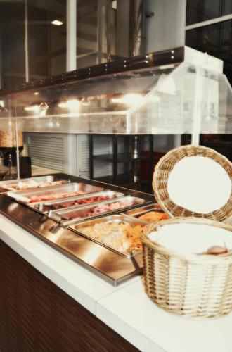 a kitchen with many different types of food at Astron Hotel in Ierápetra