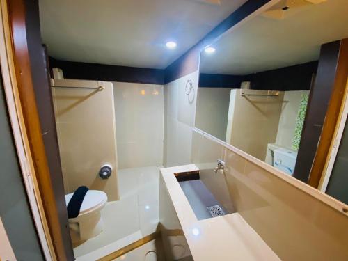 a bathroom with a sink and a toilet and a mirror at Pakor Boutique Resort in Phangnga