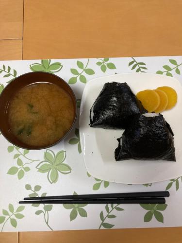 a table with a plate of food and a bowl of soup at Home Yasuda in Otaru