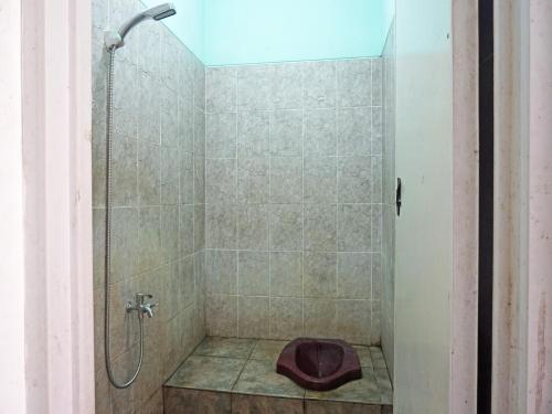 a bathroom with a shower with a toilet in it at SPOT ON 91860 Amazon Homestay Syariah 2 in Sukabumi