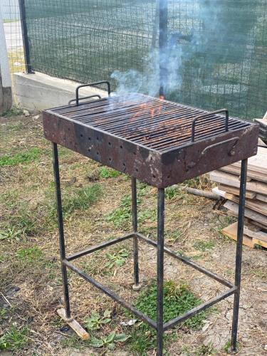 a bbq grill with smoke coming out of it at Cabana EvAy in Ocnele Mari