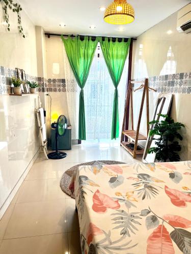 a bedroom with a bed and a green curtain at HY Local Budget Hotel - 5 mins walk to Hoi An Ancient Town in Hoi An