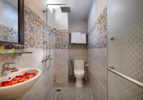 a bathroom with a sink and a toilet at Azura Gold Hotel & Apartment in Nha Trang