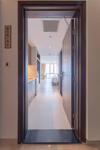 an open door leading to a hallway with a kitchen at SeaHaven Panorama Nha Trang Superview Apartments in Nha Trang