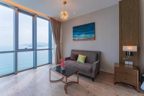 a living room with a couch and a table at SeaHaven Panorama Nha Trang Superview Apartments in Nha Trang