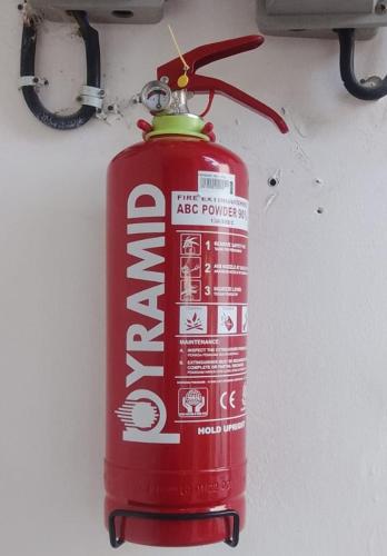 a red fire hydrant is hanging on a wall at The Mally Homestay in Gili Trawangan