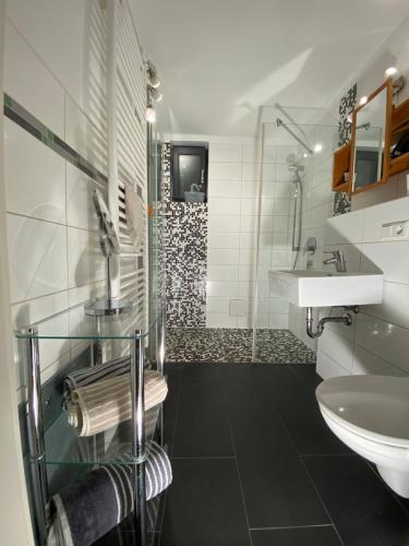a bathroom with a sink and a shower at Black Forest Villa in Lahr