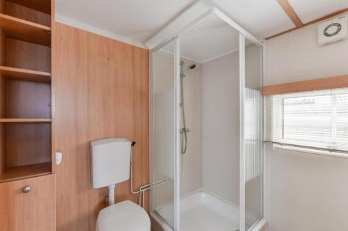 a bathroom with a shower and a toilet in it at CHALET FOR 2 AT THE BEACH in Zandvoort