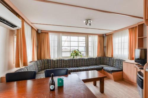 a living room with a couch and a table at CHALET FOR 2 AT THE BEACH in Zandvoort