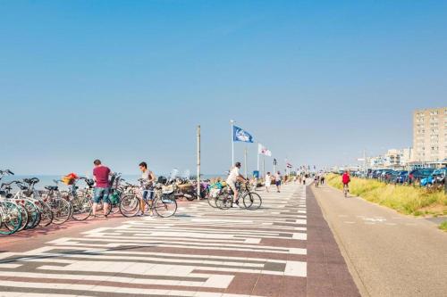 a group of people riding bikes on the beach at CHALET FOR 2 AT THE BEACH in Zandvoort