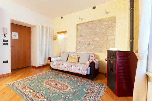 a living room with a couch and a tv at Patrioti 51 - Asiago Centro in Asiago
