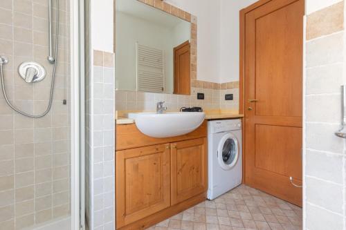 a bathroom with a sink and a washing machine at Patrioti 51 - Asiago Centro in Asiago