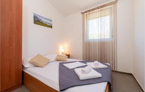 a bedroom with a bed with two towels on it at Lovely Apartment In Seline With Wifi in Seline