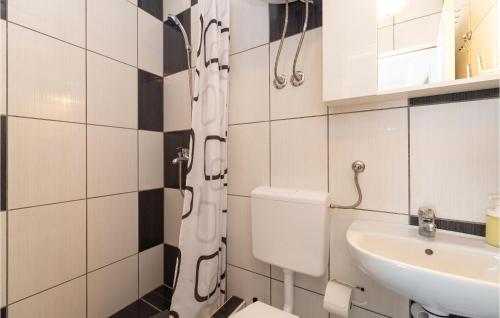 a bathroom with a toilet and a sink at Lovely Apartment In Seline With Wifi in Seline