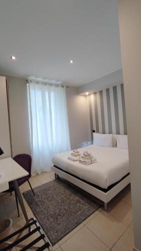 a bedroom with a bed and a chair and a table at Il Roseto in Frosinone