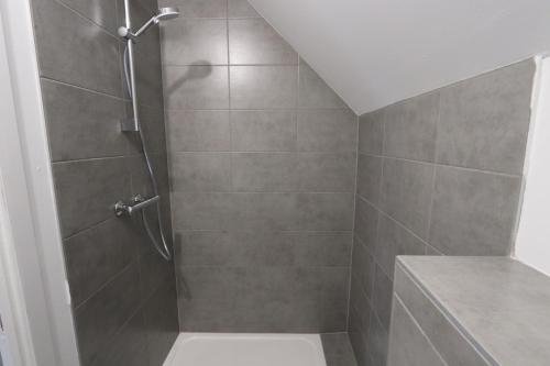 a bathroom with a shower with a toilet and a sink at Homeday FERME KLEIN in Haguenau