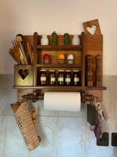 a bathroom with a shelf with spices and a paper roll at Bolla Nyaralóház in Hegyhátszentjakab