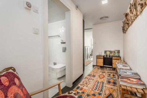 a room with a bed and a sink in it at Super artist's apartment with parking in Tel Aviv