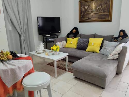 a living room with a couch and a table at Πέτρινο στη θάλασσα in Nafpaktos