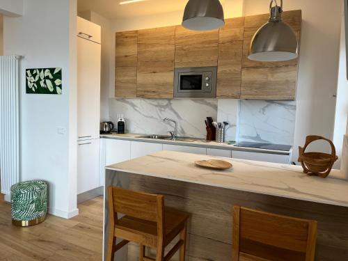 a kitchen with wooden cabinets and a counter top at CaseMaggi Sea View Terrace in Portovenere