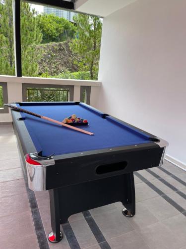 a pool table with two cuesticks on top of it at Villa 16pax 3BR with Spa Pool n Pool Table near SPICE ARENA in Bayan Lepas