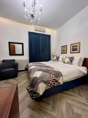 a bedroom with a large bed and a chandelier at Bonita Inn in Amman