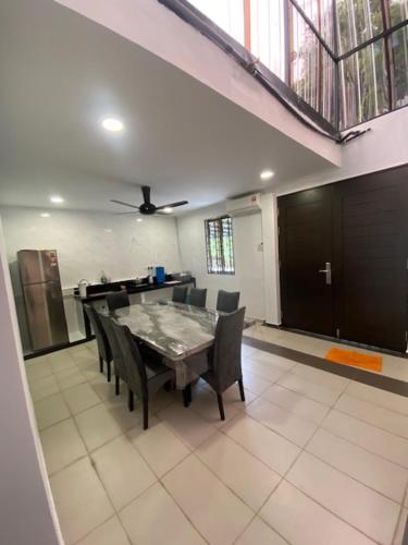 a dining room with a table and chairs at Villa 16pax 3BR with Spa Pool n Pool Table near SPICE ARENA in Bayan Lepas